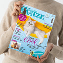 Person in beigefarbenem Pullover hält das Magazin „Geliebte Katze“, Ausgabe Juli 2026, vor hellem Hintergrund. Titelblatt mit hellblauem Grund, einer weißen Katze mit grünen Augen, liegend in einer gelben Hängematte. Texte u. a.: „Einfach cool bleiben!“, „Tele-Medizin – echte Alternative zum Praxis-Besuch?“, „Funktionale Snacks“, „Tapfere Katze Lini“, „Plötzlich Zoff!“, „Lieben wir unsere Katzen zu sehr?“ und Hinweis auf „Großer Ratgeber Tatort Blumentopf“.