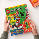 Titelblatt des LEGO-Magazins „Minecraft“ Nr. 45 mit grünem Creeper als Hauptmotiv vor rotem und weißem TNT-Hintergrund. Sichtbare Texte: „DIESMAL MIT CREEPER + TNT-SCHLEUDER + EXPLOSIONSEXPERTE“, „STARKES LEGO EXTRA!“, „INTERAKTIVER COMIC!“, „2 COOLE POSTER“, „EXKLUSIV! LIMITIERTE KARTE Nr. 11“. Zwei Hände halten das Heft über einer hellen Oberfläche neben einem orangefarbenen Tablett.