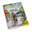 Titelbild des Magazins „e-bike TOUREN“ mit gelb-weißem Schriftzug auf blauem Hintergrund; zentral eine weiblich gelesene Person mit Sonnenbrille, Helm und rotem Shirt auf einem E-Bike vor alpiner Dorflandschaft. Textausschnitte: „Faszinierende Reiseziele“, „30 Reisetipps“, „E-BIKE HIGHLIGHTS 2025“, „Radfahren in Österreich“, „Flussradwege“, „Berge, Wälder und Seen“, sowie weitere Reportagetitel und Gewinnspielhinweis.