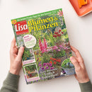 Titelbild der Zeitschrift „Lisa Blumen & Pflanzen“, Ausgabe August 2026, mit großem gelbem Schriftzug auf grünem Hintergrund und Foto eines sommerlichen Gartens mit bunten Dahlien, Zinnien und dekorierten Blumentöpfen; runde Textelemente mit Überschriften wie „Jetzt freuen wir uns auf…“ und „Endlich Dahlienzeit!“; gehalten von zwei Händen über hell beigem Untergrund, oben rechts eine orangefarbene Schale.