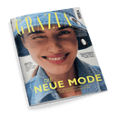 Titelbild der Zeitschrift „GRAZIA“ mit einer frontal abgebildeten lächelnden weiblich gelesenen Person, die ein Auge zuzwinkert und einen hellblauen Jeans-Bucket-Hat sowie eine passende Jeansjacke trägt; Aufschriften u. a.: „DIE NEUE MODE – Die angesagtesten Labels und Gute-Laune-Pieces“, „HOLLYWOODS BESTE PARTY – Unterwegs bei den Golden Globes“ und „GRAZIA HOT-LIST – Kate Moss, Sebastian Fitzek, Lindsay Lohan, Cher“.