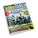 Titelbild des „e-bike TOUREN MAGAZIN“ mit Untertitel „Ein Sonderheft von Bike&Travel“, Ausgabe 02-26 Frühling/Sommer. Im Vordergrund eine weibliche und eine männliche Person auf schwarzen E-Bikes auf einem Schotterweg, Hintergrund mit Bäumen und Wiese. Text: „20 Traumtouren für Genießer“, „Märchenhafte Mittelgebirge – Unterwegs im Harz, Spessart und Schwarzwald“, „Marktcheck E-Bike-Motoren“.