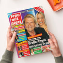 Titelbild der Illustrierten „Frau mit Herz“, gehalten von zwei Händen über einer weißen Oberfläche. Im Mittelpunkt ein älterer Mann und eine blonde Frau vor blauem Hintergrund. Schlagzeilen u. a.: „Magerschock – Matthias Reim: Große Angst um seine Frau“, „König Charles – Nach dem Skandal-Interview“, „Beatrice Egli – Auf der Suche“, „Süße Erdbeerträume“. Farben dominieren in Rot, Gelb, Blau und Weiß, Layout in typischer Magazinstruktur.