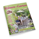 Titelbild der Zeitschrift „Wohnen & Garten“, Ausgabe Juni 2025. Abgebildet ist ein sommerlich dekorierter Gartentisch mit Holzmöbeln, Glasflaschen, Blumen und Sonnenschirm in grün bepflanzter Umgebung. Textelemente: „Willkommen im Sommersalon“, „Garten & Blumen – Rosen richtig schneiden, pflegen und düngen“, Rubriken „Wohnen“, „Garten“ und „Dekorieren“, Hinweis auf „Köstliche Rezepte mit Kirschen“.