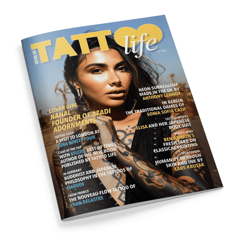 Titelbild der Zeitschrift „Tattoo Life“ Ausgabe Nr. 155 mit einer dunkelhaarigen, tätowierten weiblichen Person im Vordergrund, vor einem unscharfen, naturbelassenen Hintergrund; sichtbare Texte u. a.: „NAHAL FOUNDER OF AZADI ADORNMENTS“, „A VISIT TO LONDON AT OUR NINETY FOUR“, „NEON SURREALISM MADE IN THE UK BY ANTHONY LENNOX“, „BEN ASHTON’S FRESH TAKE ON CLASSICAL PAINTING“ und weitere Themen zu Tattoos, Kunst und Kultur.