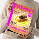 Weibliche Person im beigefarbenen Strickpullover hält schräg eine orangefarbene Zeitschrift mit pinkem Titel „FEINSCHMECKER“ und dem Text „Das Leben genießen: Reisen, Essen & Trinken“. Auf dem Cover: ein angerichtetes Fischgericht mit Kaviar und Blumen sowie die Überschriften „Bodensee in Bestform“, „20 Top-Adressen“, „Portugals Genuss-Oasen“ und „Neue Küchenwelten“.