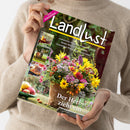 Weibliche Person im beigefarbenen Strickpullover hält ein schräg fotografiertes Magazin mit dem Titel „Landlust“. Auf dem Cover stehen „Neue Strickideen“ und „Der Herbst zieht ein“; abgebildet sind ein üppiger Blumenstrauß, herbstliches Obst, ein Hirsch, ein Gebäck sowie kleine Natur- und Gartenmotive.
