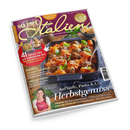 Schräg liegendes, glänzendes Kochmagazin „So is(s)t Italien“ mit violettem Cover, großem Foto eines Auflaufs mit Pasta, Hackbällchen, Tomatensoße, Parmesan und Basilikum. Sichtbare Texte: „Für Ihre italienischen Momente“, „82 geniale Rezepte“, „Kürbis: 13-mal köstlich“, „Ofengerichte“, „Aufläufe, Pasta & Co. Herbstgenuss“; unten ist eine weibliche Person mit dunklem Haar und roter Schürze abgebildet.